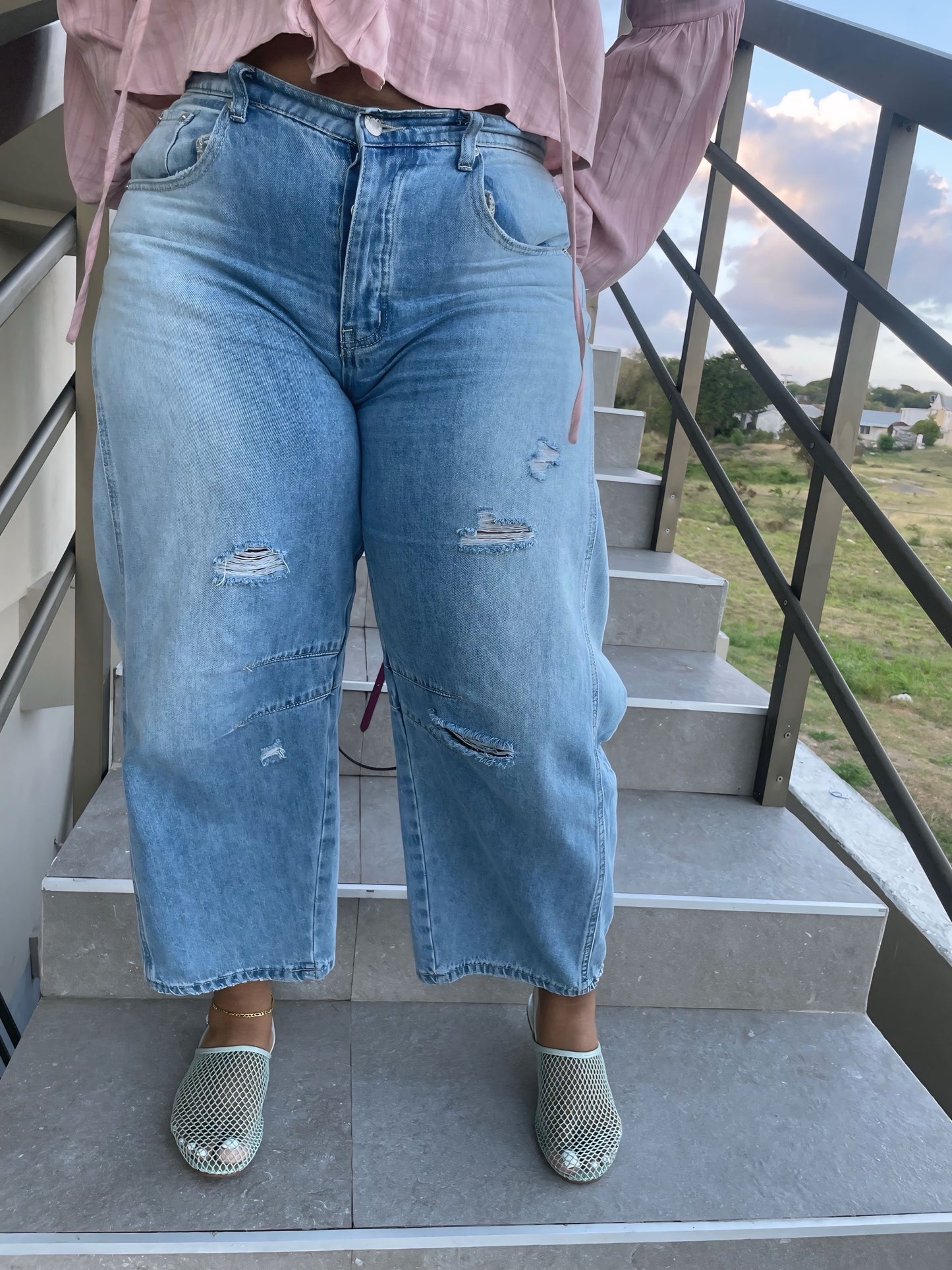 Distressed mid rise barrel ankle jeans